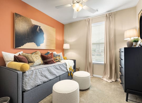 a bedroom with a bed and a ceiling fan