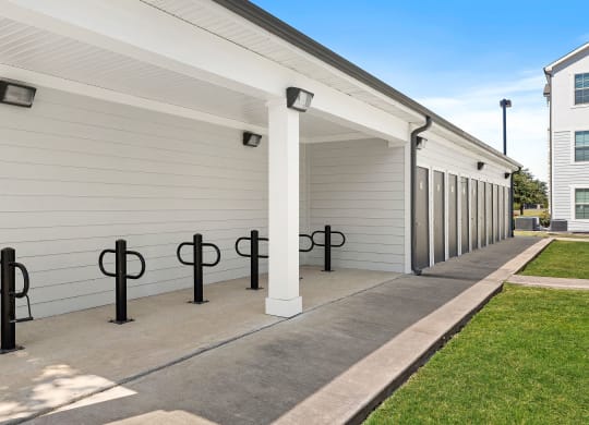 a row of garage doors at the whispering winds apartments in pearland, tx
