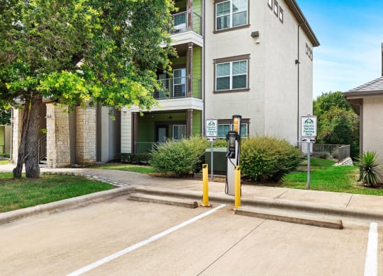 a parking meter in front of an apartment building