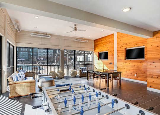 A foosball table is in the middle of a living room.