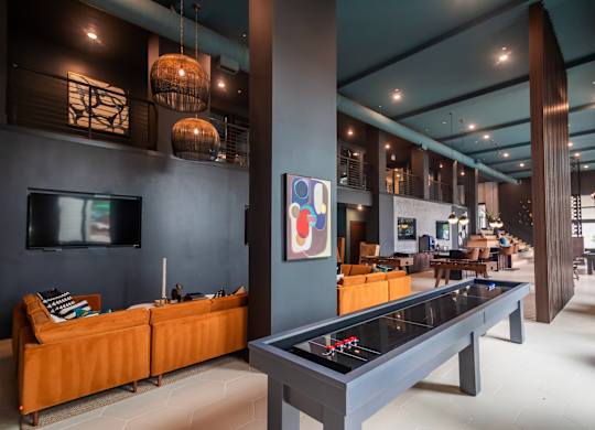 A room with a pool table and a television.