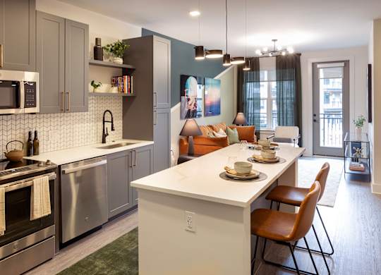 an open kitchen and living room with a table and chairs