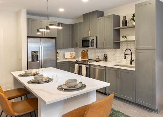 a kitchen with stainless steel appliances and a white table