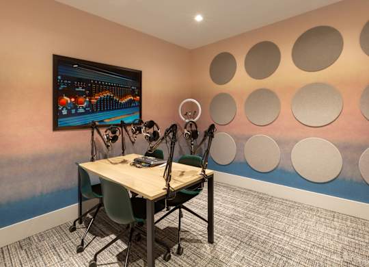 a conference room with a table and chairs and a wall with circles on the wall