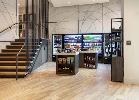 the lobby of a store with a vending machine and stairs