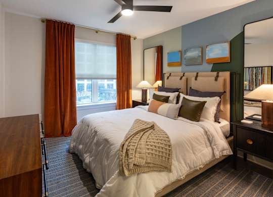 a bedroom with a large bed and a window