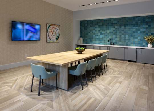 a dining room with a wooden table and chairs