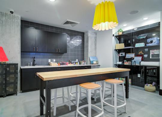 a kitchen with a long island with three stools in front of a counter top