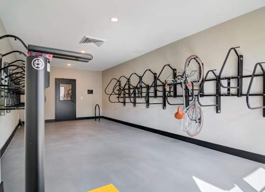 a bike rack hangs on the wall in a room with a concrete floor