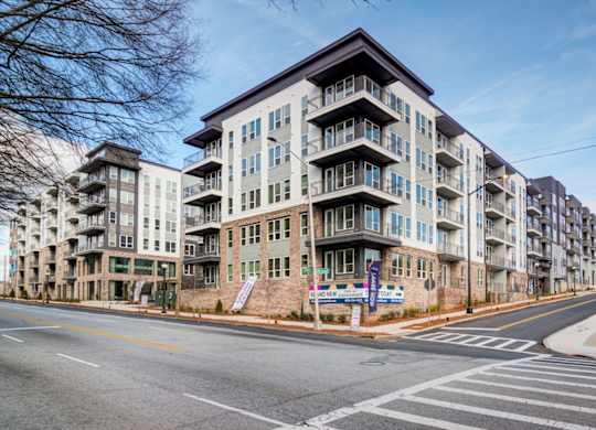 a large apartment building on the corner of a city street