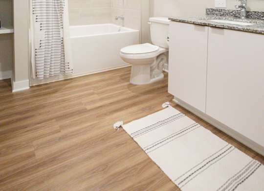 a bathroom with a shower toilet and sink and a mirror