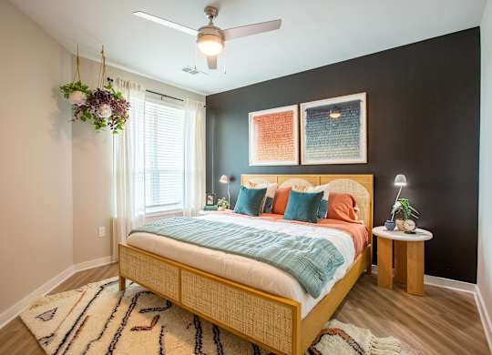 a bedroom with a bed and a ceiling fan