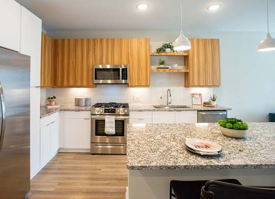 a modern kitchen with stainless steel appliances and granite counter tops