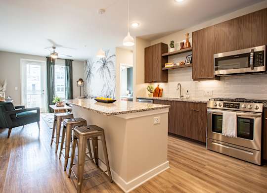 an open kitchen with a large island with bar stools