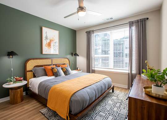 a bedroom with a bed and a ceiling fan
