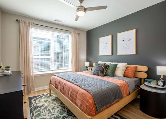 a bedroom with a bed and a ceiling fan