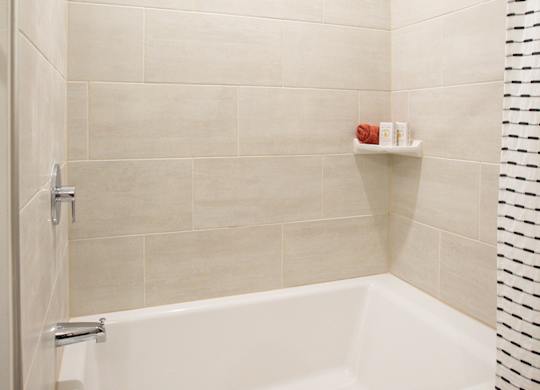 a white bath tub in a bathroom with a shower curtain