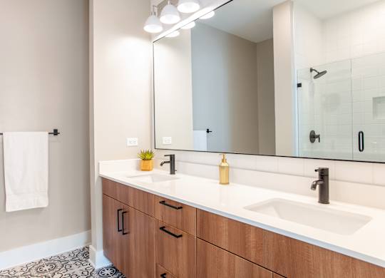 a bathroom with two sinks and a mirror