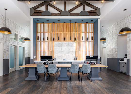 A modern office space with a long table and chairs.