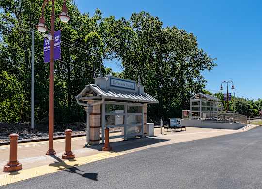 A bus stop with a shelter and a sign that reads "Dunster St.".