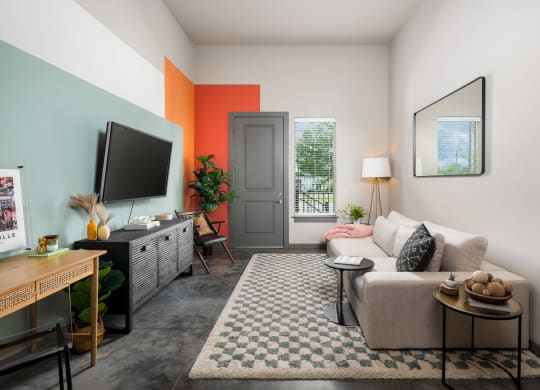a living room with a couch and a tv on a stand
