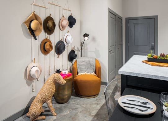 a selection of hats hangs from the wall in the entry of the apartment