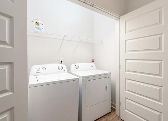 A white washing machine and dryer in a small laundry room.