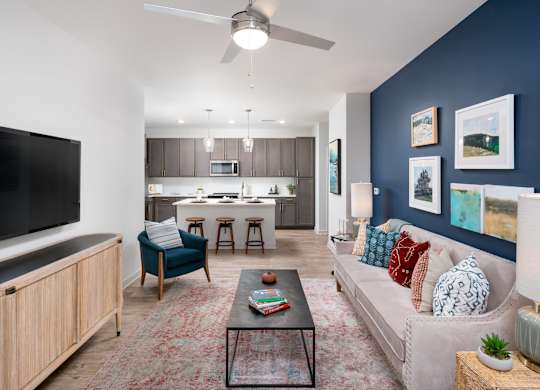 A living room with a blue chair and a black coffee table.