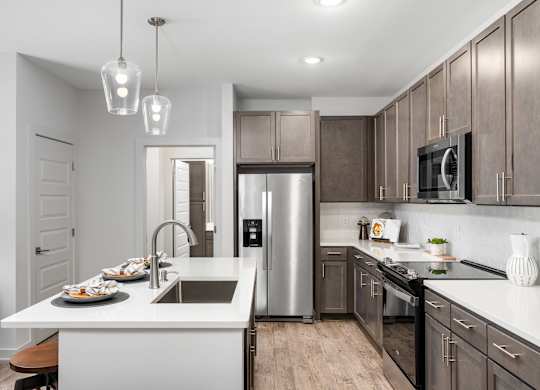 A modern kitchen with a stainless steel refrigerator and wooden cabinets.