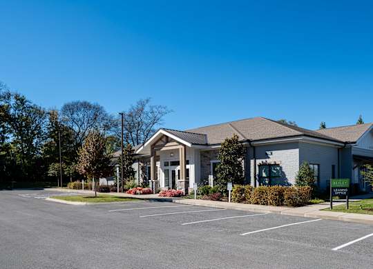 A building with a parking lot in front of it.
