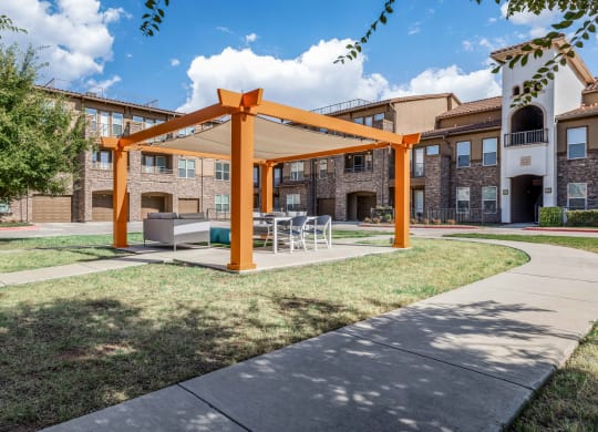 our apartments offer a patio with a table and chairs