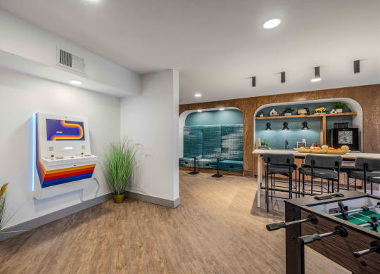a game room with a pool table and a bar
