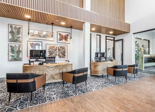 a lobby with a desk and chairs and a reception area