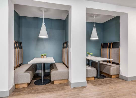a dining room with tables and chairs and blue walls