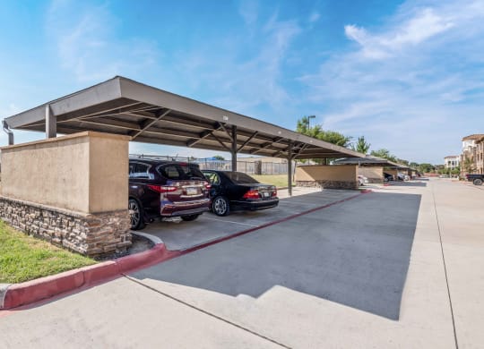 a parking garage with cars parked under it