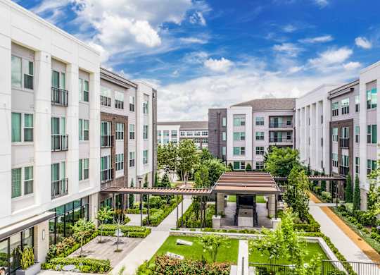 A modern apartment complex with a courtyard garden.