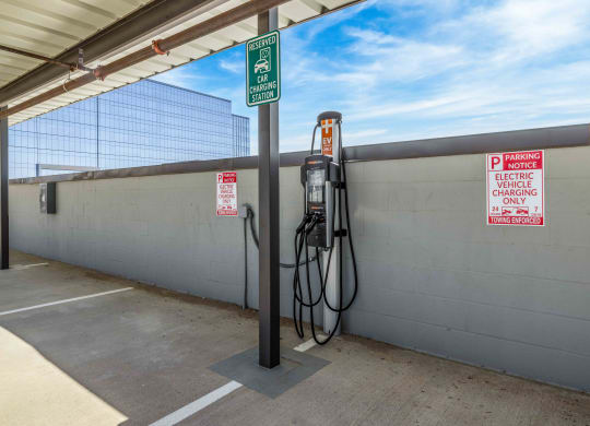 an electric vehicle charging in a parking garage