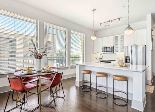 a kitchen with a large island with a breakfast bar and stools