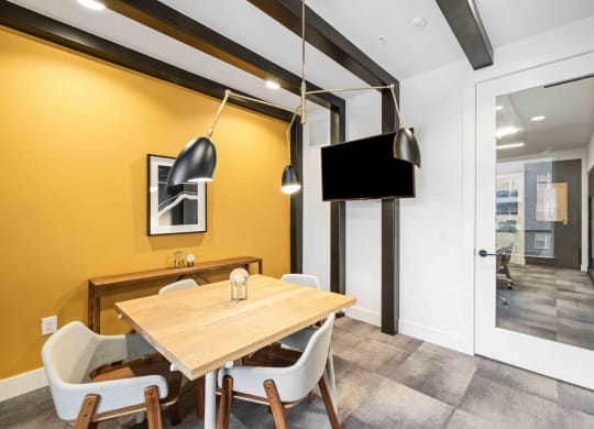 a dining room with a table and chairs and a tv