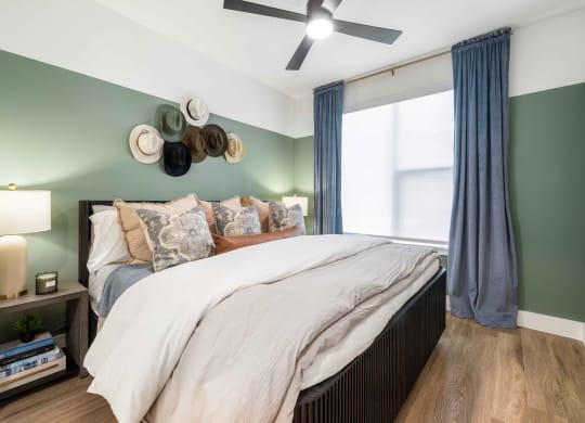 a bedroom with a bed and a ceiling fan