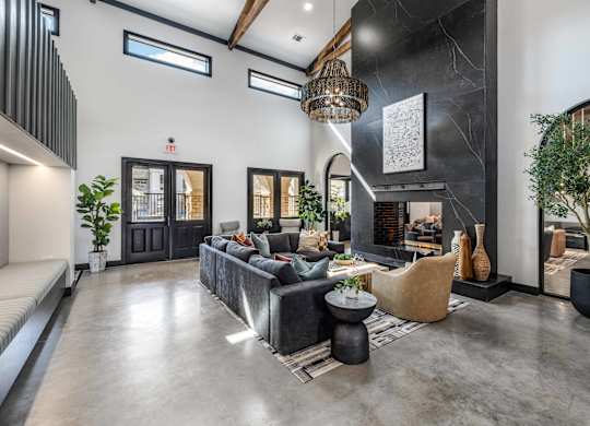 A modern living room with a grey sofa and a black coffee table.