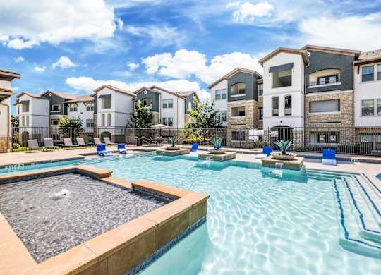 A swimming pool surrounded by residential buildings.