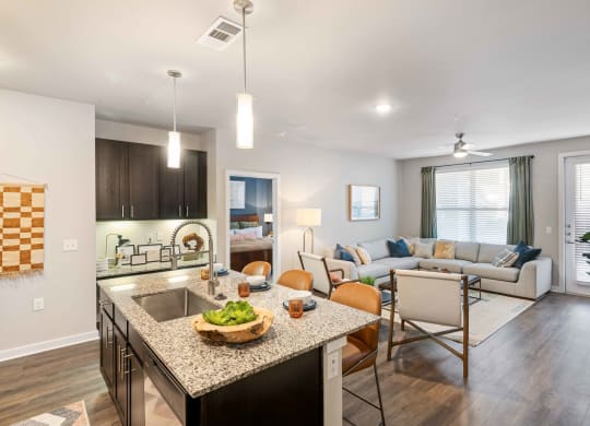 a living room with a kitchen and a dining room