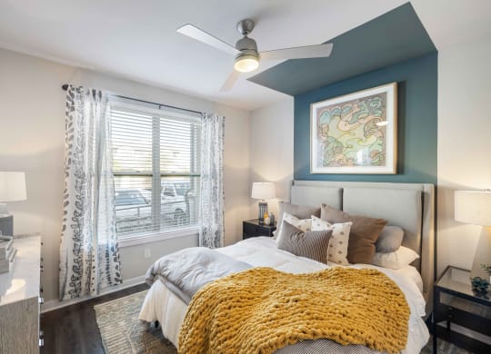 a bedroom with a large bed and a ceiling fan