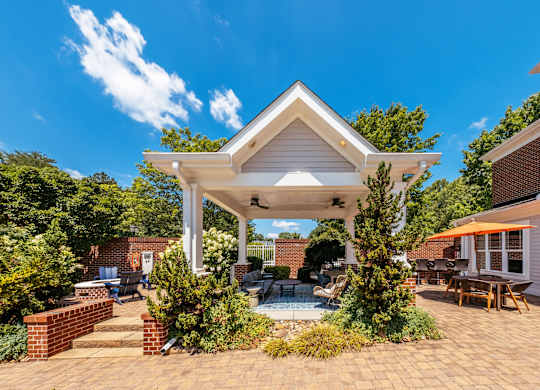 A house with a white roof and a patio with a table and chairs.