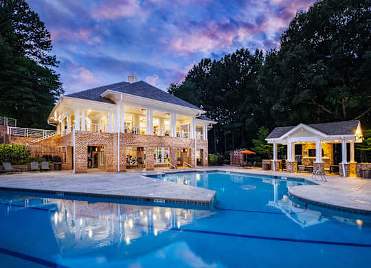 A large house with a pool in front of it.