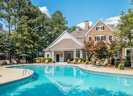A large house with a pool in front.