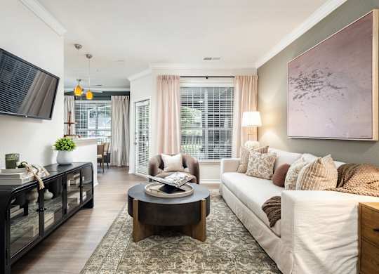 A living room with a white couch and a coffee table.