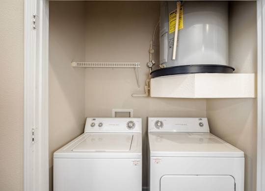 A white washing machine and dryer in a small laundry room.