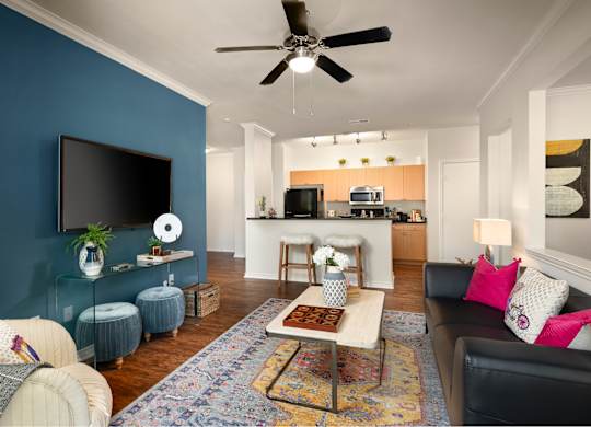 A living room with a blue wall and a television.